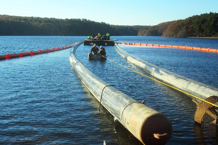 Floating 24 inch piping into Long Pond in preparation to accept directional drilling head