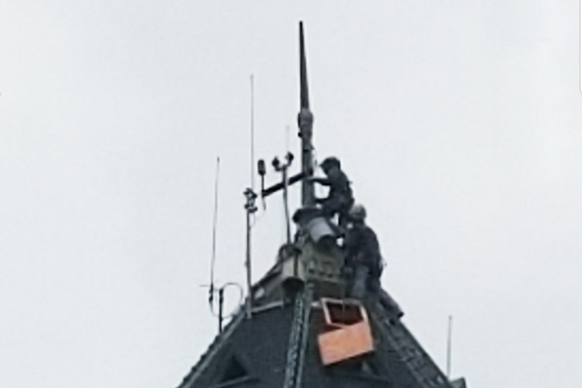 Placing the repaired spire on top of the High Service Water Tower