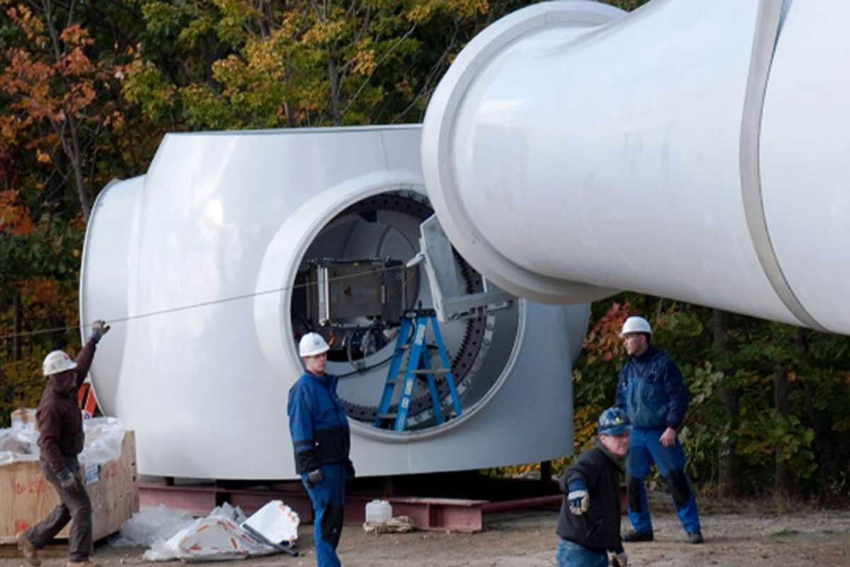 Attaching the wind turbine blades.