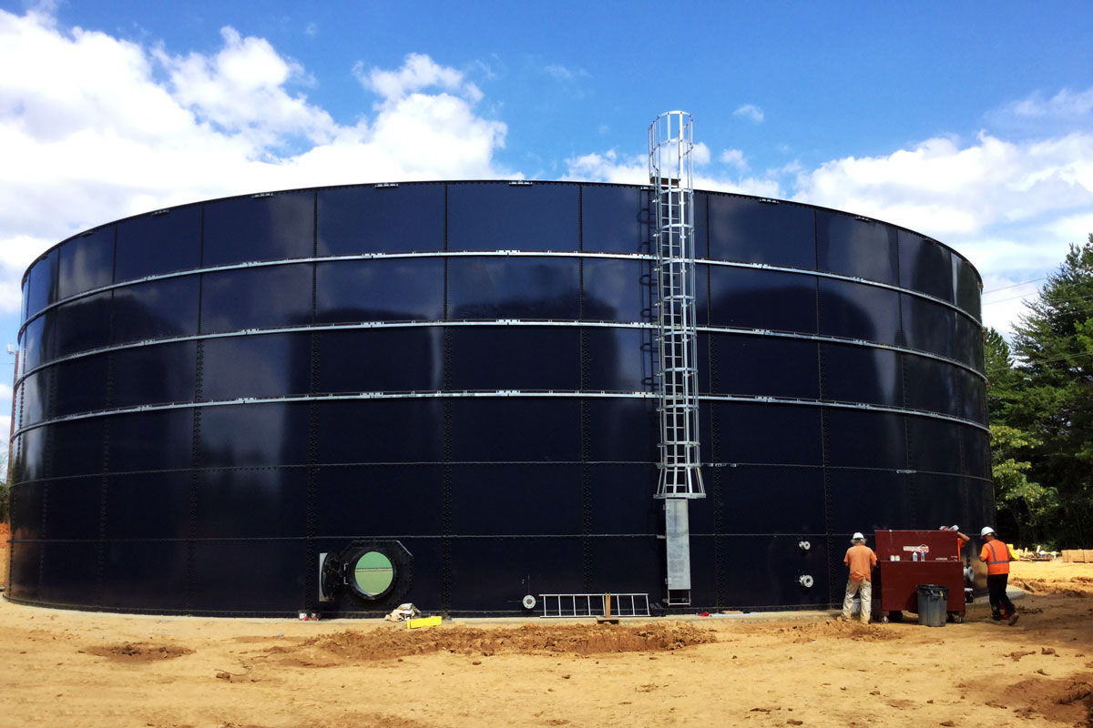 Installing ladders and connections to one of the tanks.