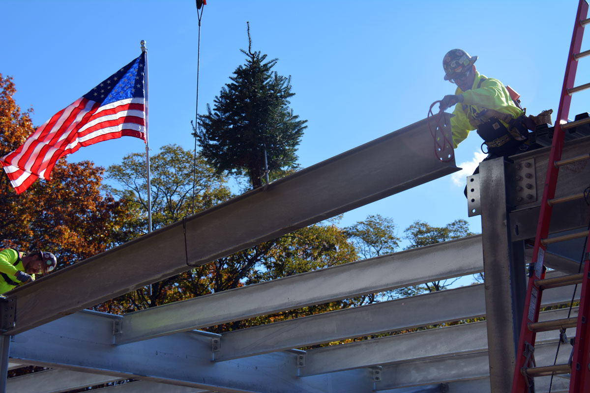 Placing the last structural steel member during the topping off ceremony